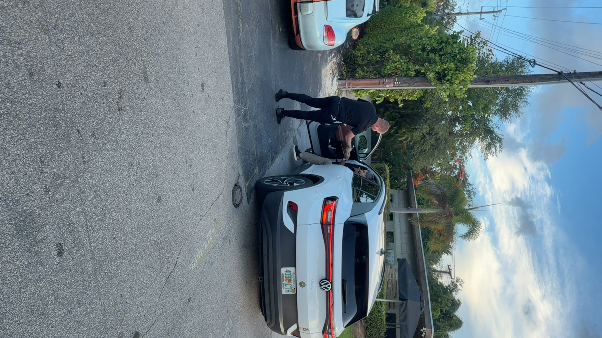 AV Valet attendant handing keys back to a guest curbside in Miami